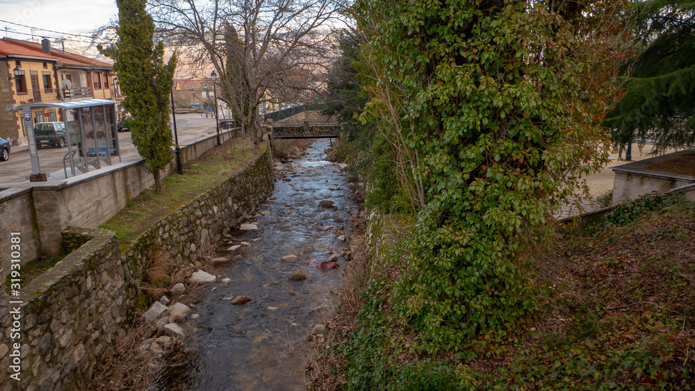 Beautiful snowy landscape of Guadarrama mountains in a small medieval town of Rascafria near the Spanish capital Madrid in winter. Famous touristic attraction for winter sports, leisure in Spain