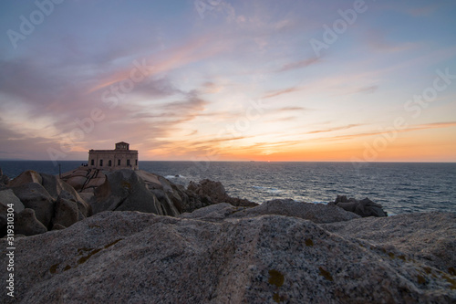 Sunset at the Capotesta lighthouse in Sardinia photo