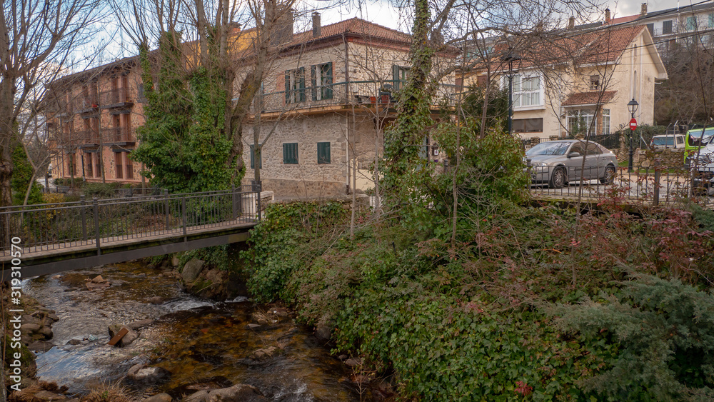 Beautiful snowy landscape of Guadarrama mountains in a small medieval town of Rascafria near the Spanish capital Madrid in winter. Famous touristic attraction for winter sports, leisure in Spain