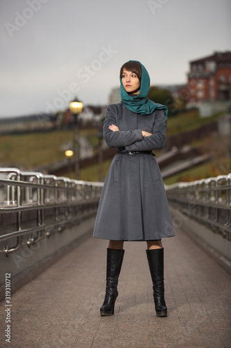 Young fashion woman in gray classic coat and head scarf