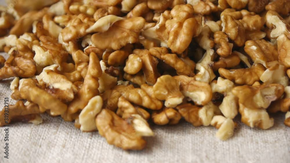 Peeled Walnut Kernels Falling On The Tableclots Peeled Walnut Kernels Falling On The Tableclots