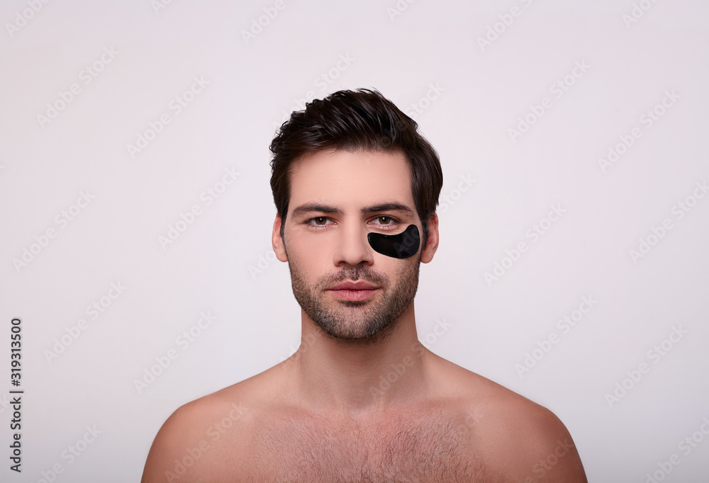 Obraz premium Serious brunette with black patches on her face.