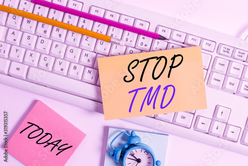 Text sign showing Stop Tmd. Business photo showcasing Prevent the disorder or problem affecting the chewing muscles Flat lay above empty note paper on the pc keyboard pencils and clock photo