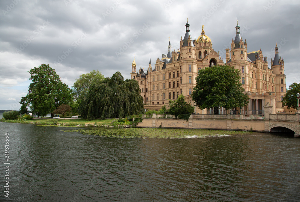 City palace in Schwerin with lake bridge and park