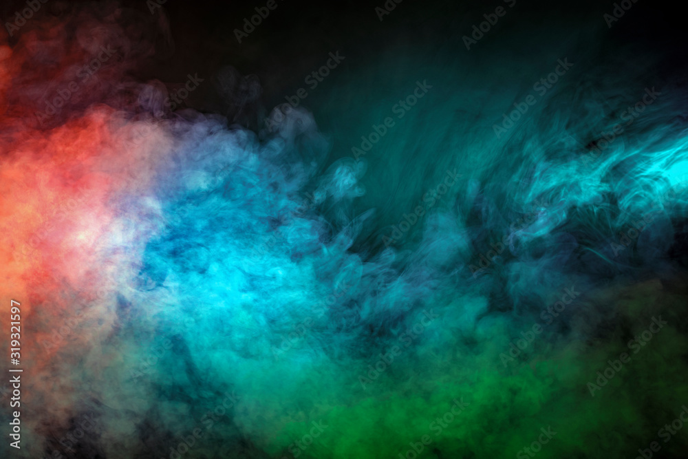 Abstract backlit smoke texture in red blue green on black background.