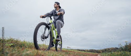 A man on a bicycle in the autumn on a field road