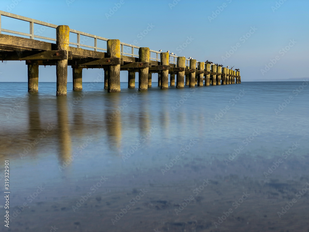 Wooden pier at the shore of the ocean 