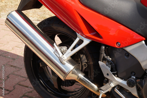 Newly Purchased Motorcycle. Side view of a clean exhaust pipe.