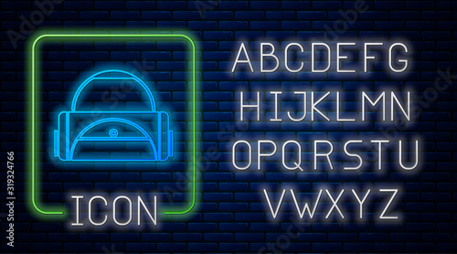 Glowing neon Sport bag icon isolated on brick wall background. Neon light alphabet. Vector Illustration