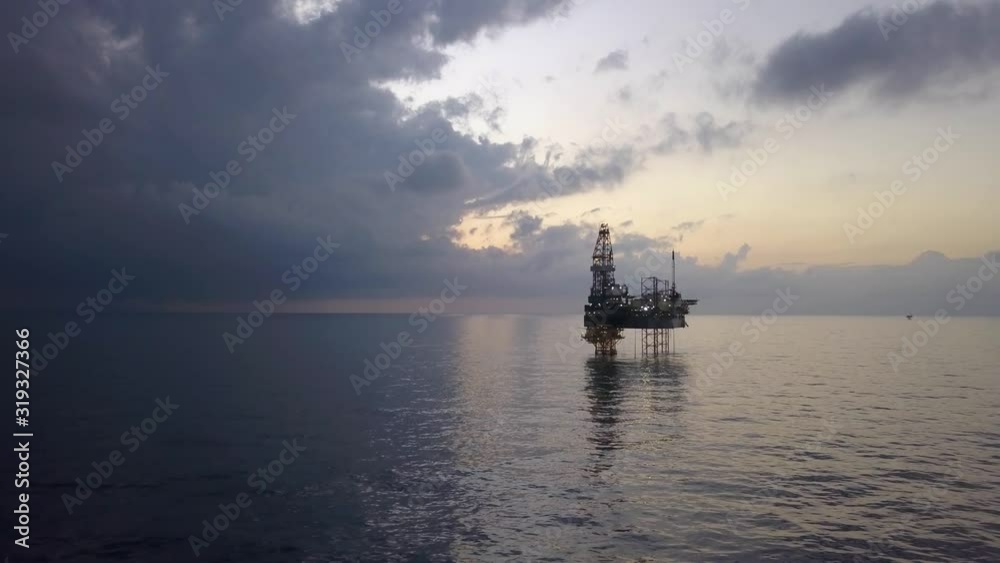 Aerial view of the jack up rig shot during sunset time. Fly around the jack up rig with a drone. Aerial view of the jack up rig shot during sunset time. Fly around the jack up rig with a drone.