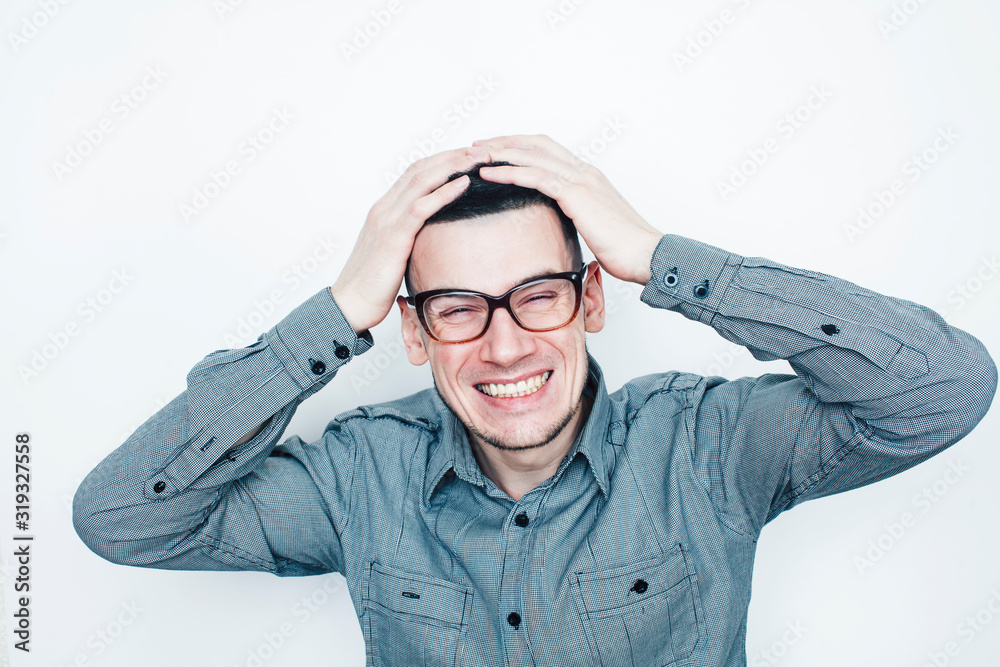 young handsome teenage hipster guy posing emotional wearing glasses, happy smiling lifestyle people concept