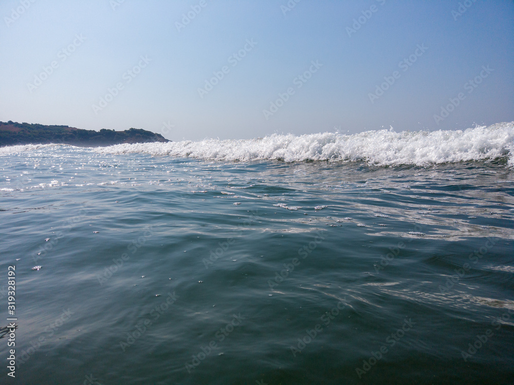 Sea waves on the beach. Sea waves in the water during the day
