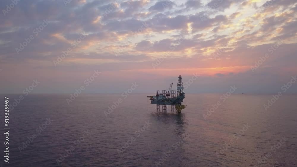 Aerial view of the jack up rig shot during sunset time. Fly around the jack up rig with a drone. Aerial view of the jack up rig shot during sunset time. Fly around the jack up rig with a drone.