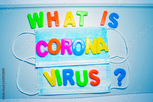 What is Coronavirus, the text is written in plastic letters in different colors on background with protective masks.