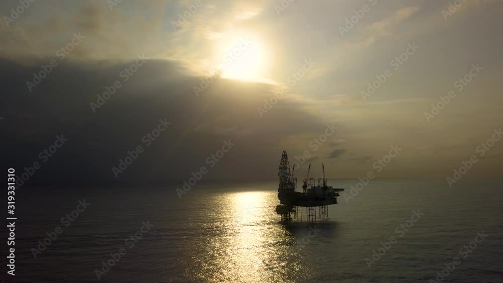 Aerial view of the jack up rig shot during sunset time. Fly around the jack up rig with a drone. Aerial view of the jack up rig shot during sunset time. Fly around the jack up rig with a drone.