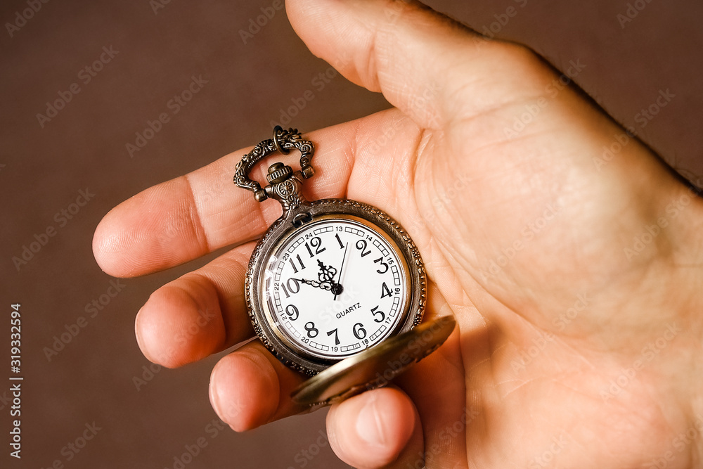 a pocket watch in the hands of a man a pocket watch in the hands of a man