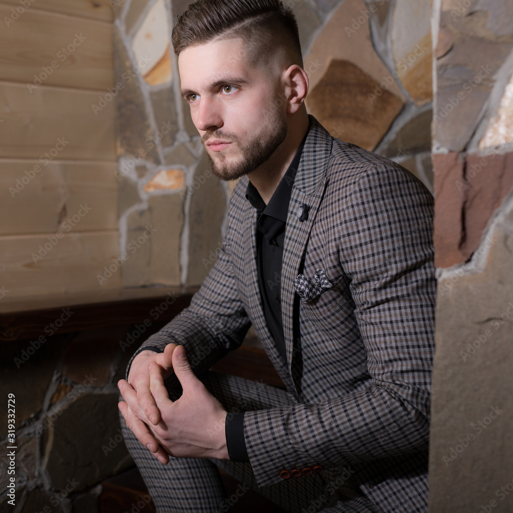 Obraz premium Handsome young elegant man in house interior.