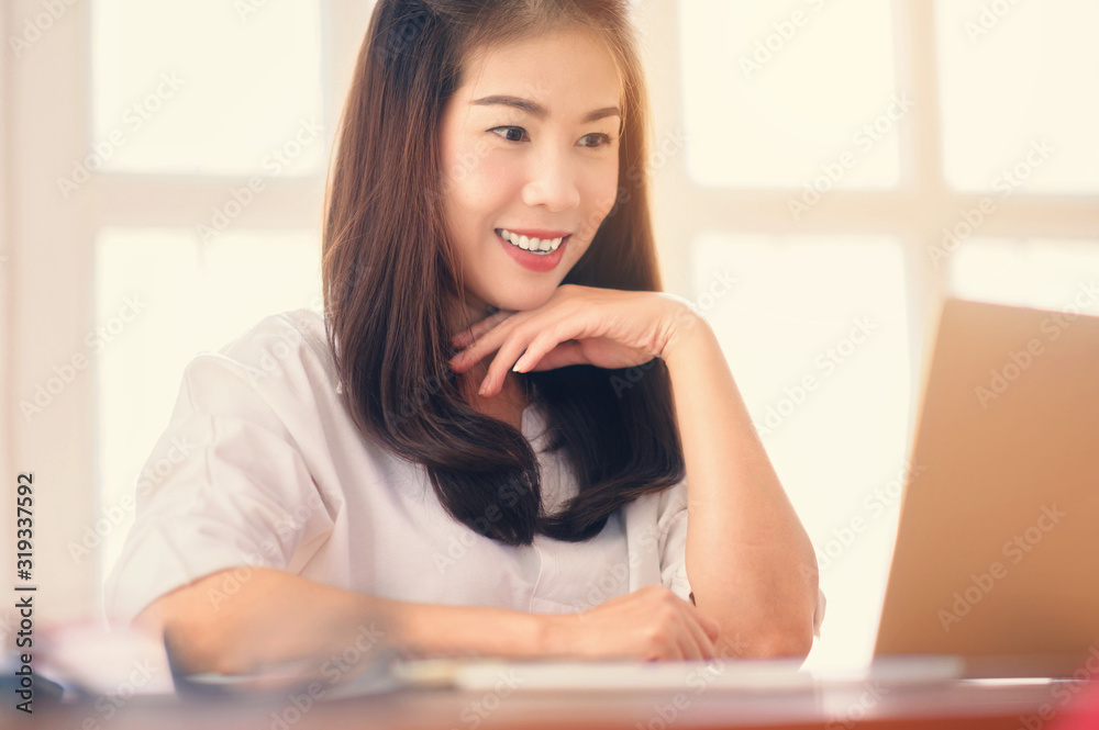 Portrait of Asian businesswoman using laptop computer at modern office.Blurred background Portrait of Asian businesswoman using laptop computer at modern office.Blurred background