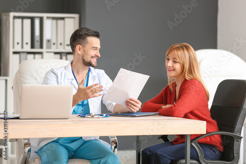 Male doctor working with pa...