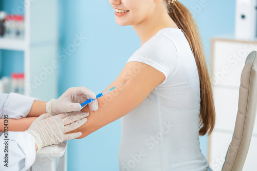 Doctor vaccinating pregnant...