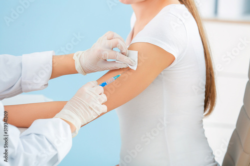 Doctor vaccinating pregnant woman in clinic