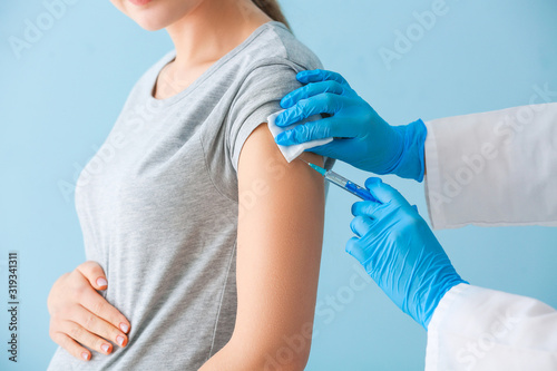 Doctor vaccinating pregnant...