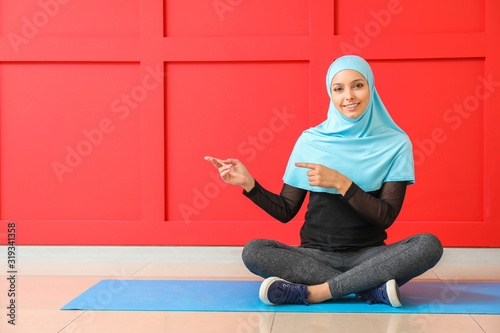 Sporty Muslim woman pointin...