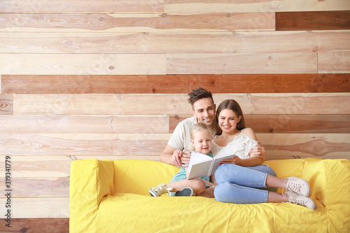 Happy young family reading ...