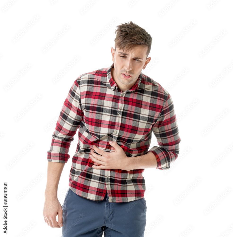 Young man suffering from abdominal pain on white background Young man suffering from abdominal pain on white background