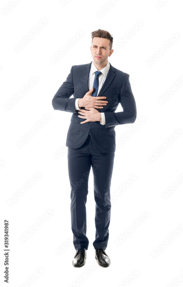 Young businessman suffering from abdominal pain on white background Young businessman suffering from abdominal pain on white background