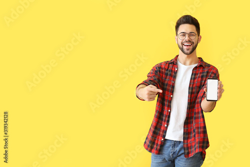 Happy young man with mobile...