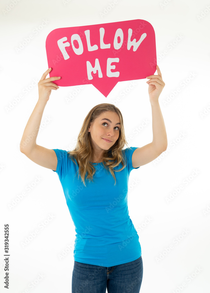 Happy young blogger woman holding Follow me social media icon to get followers Happy young blogger woman holding Follow me social media icon to get followers