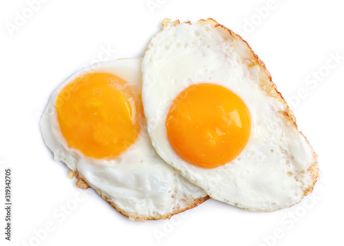 Tasty sunny side up eggs on light background