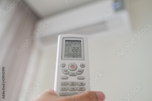 remote control air condition on hand, save power concept