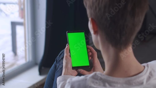 Business woman using smartphone viewing green screen on mobile phone chroma key online. Woman with telephone. Female cell phone. Reading social media. Cellphone greenscreen new technology concept.