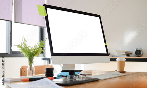 Cropped shot view of Office desk Workspace stuff with notepad, laptop and coffee cup mouse notepad shot. © wattana