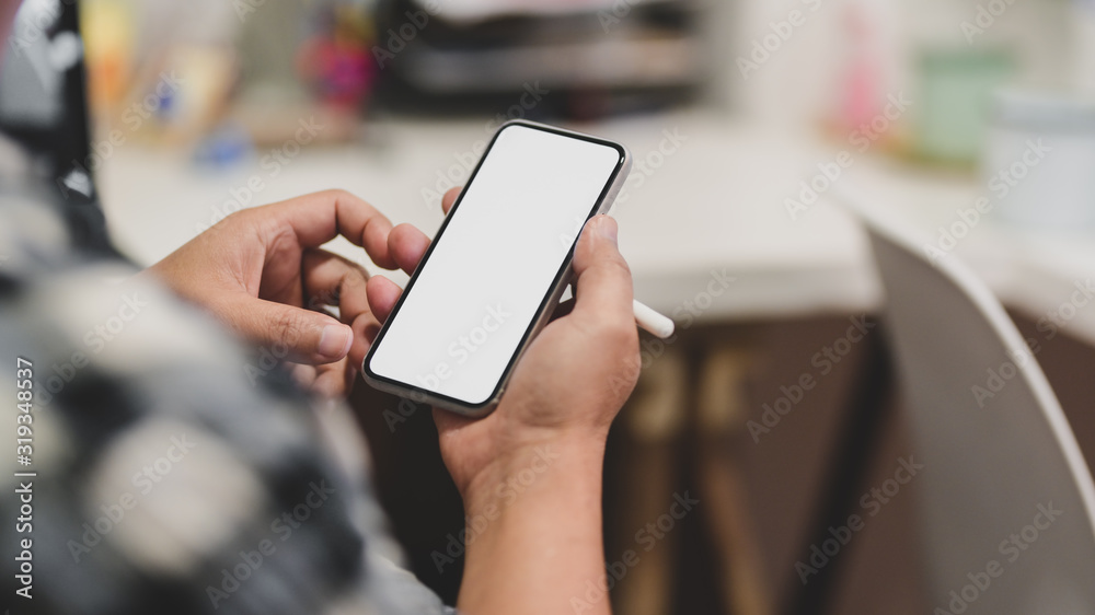 Cropped shot of a man using blank screen smartphone Cropped shot of a man using blank screen smartphone