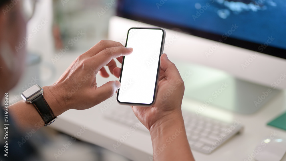 Close-up view of businessman using blank screen smartphone