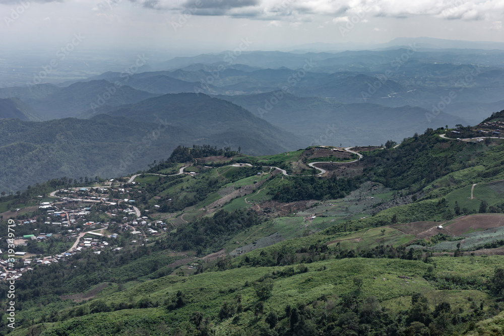 Fototapeta premium Road curve on mountain and village, Aerial View.