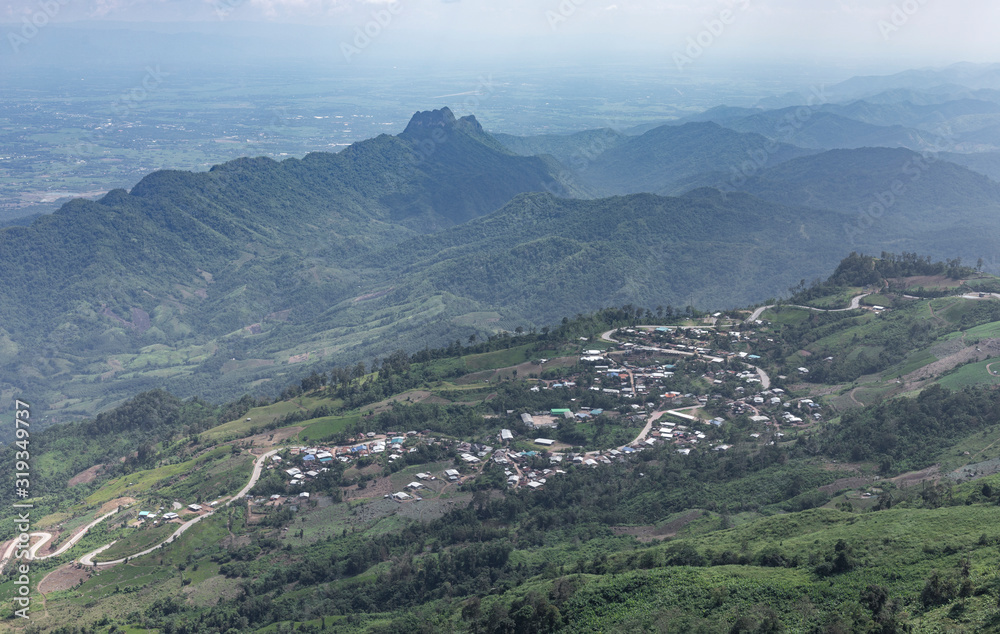 Road curve on mountain and village, Aerial View.