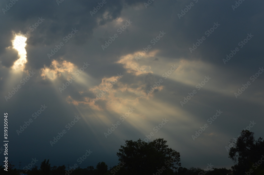 The light from the sun shining through the clouds