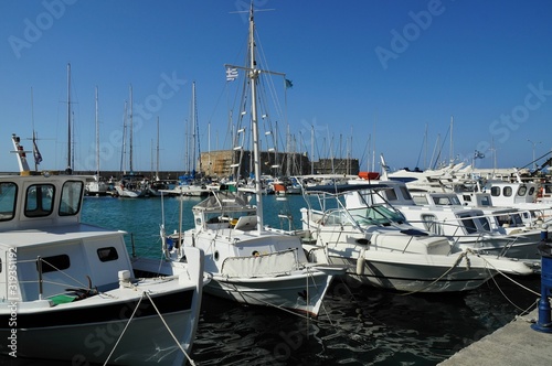 Sailing Boats at the famous ancient sea port of Agios Nikolaos, Crete island, Greece.