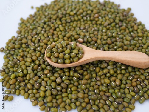 Above of green mung beans in woosen spoon. photo