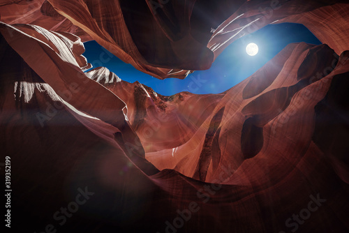 Antelope Canyon's red rock formations under a midnight blue evening sky in Page, Arizona, USA. photo