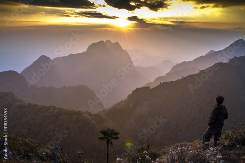 sunset in mountains with man on background