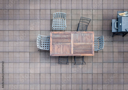 aerial birds eye view of outdoor deck with table, chairs, and bbq propane giller photo