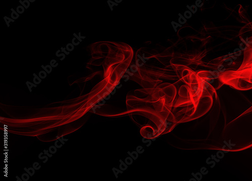 Fluffy puffs of red smoke and fog on black background, fire design