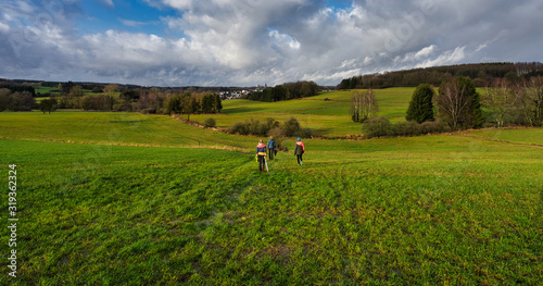 hiking family in grasslands © Tim