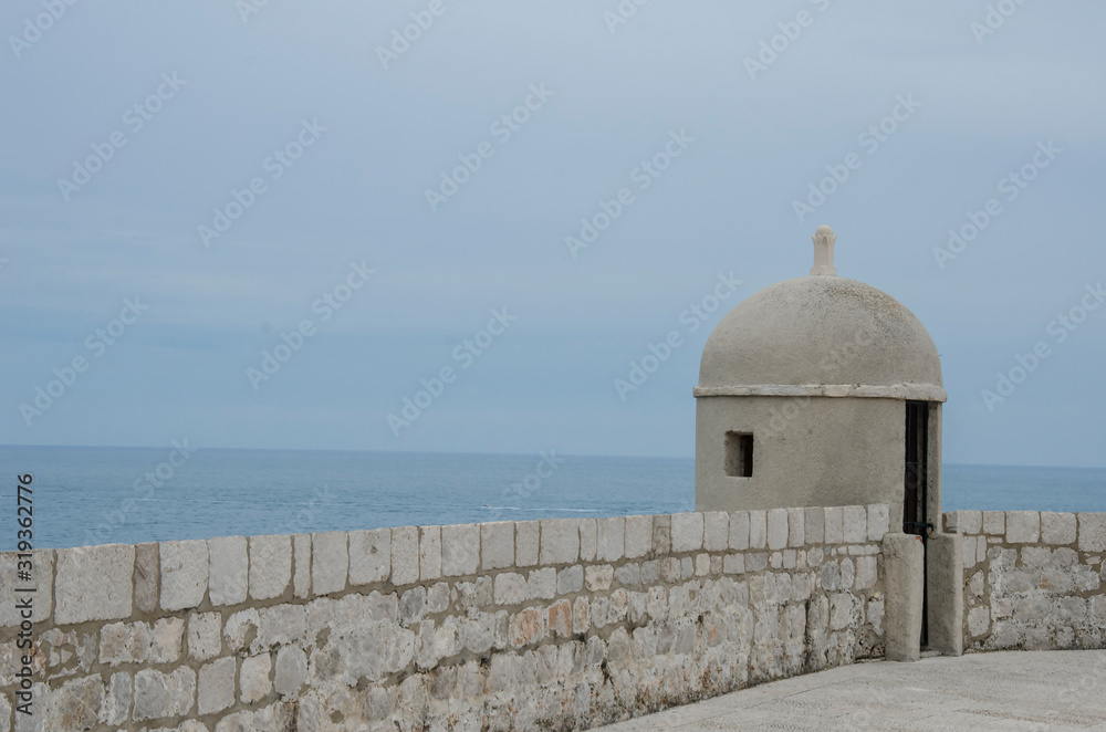 View of the gun turret on Dubrovnik city walls and sea in Croatia View of the gun turret on Dubrovnik city walls and sea in Croatia