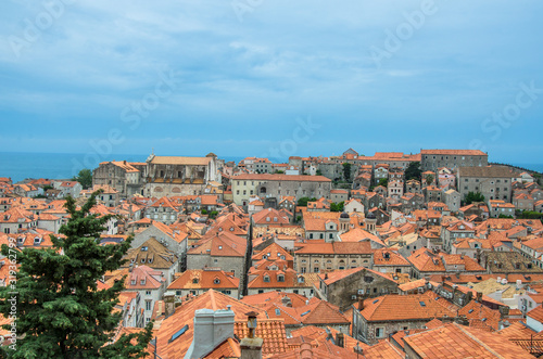 View of red rooftops and blue sea from Dubrovnik city wall, Dubrovnik, Croatia. View from above of old town center. © Maria Vonotna